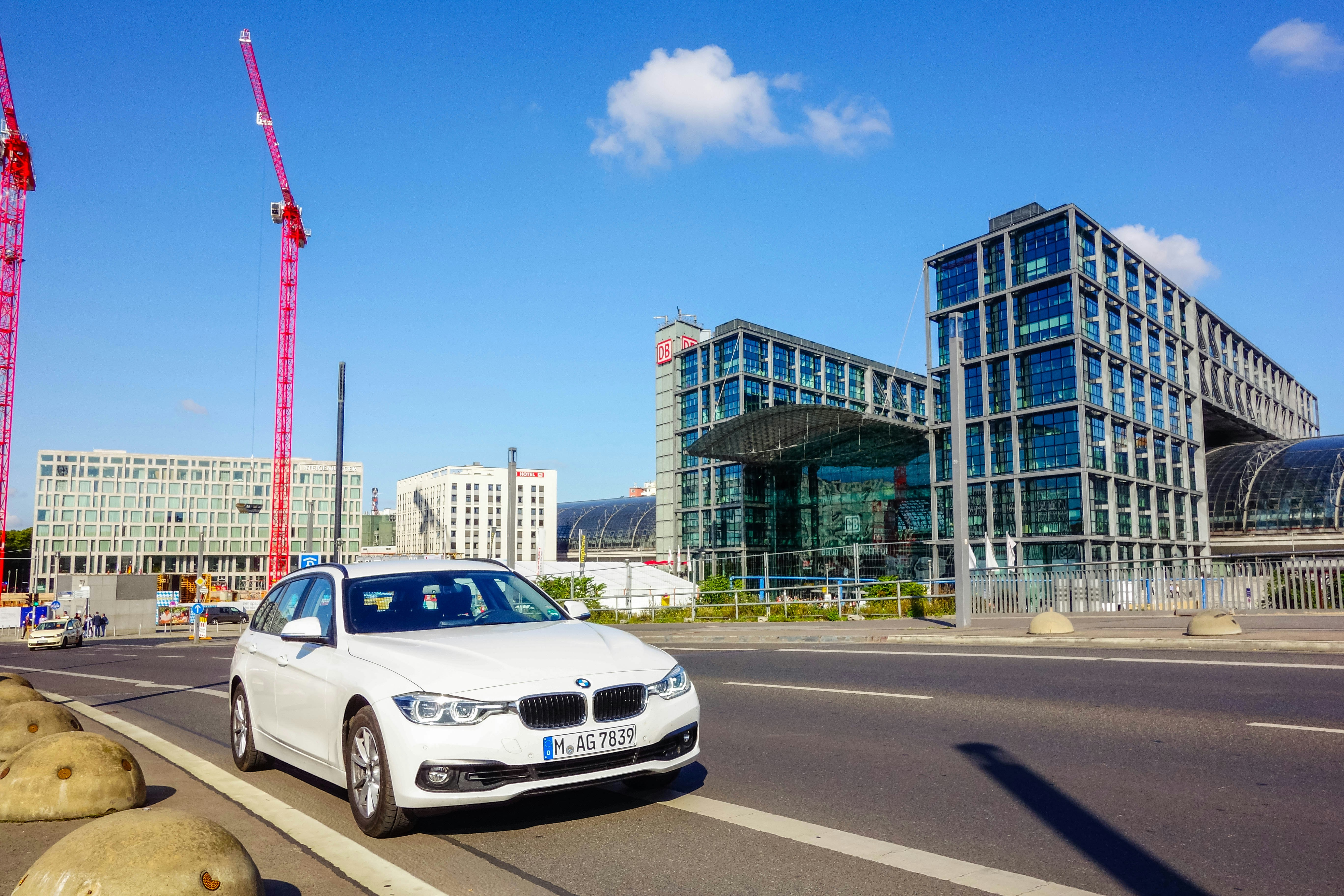 white BMW car on road